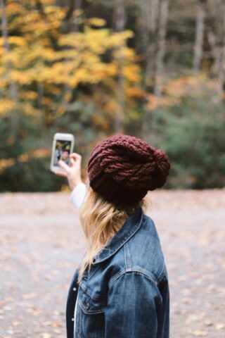 woman taking a selfie near trees