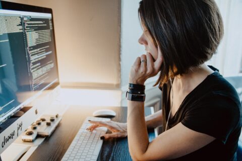 woman sitting at a desk in front of a computer