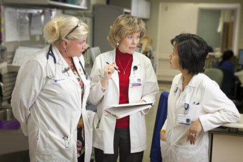 three clinicians talking about a patient