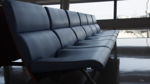 a banquette of empty leather chairs in a waiting room