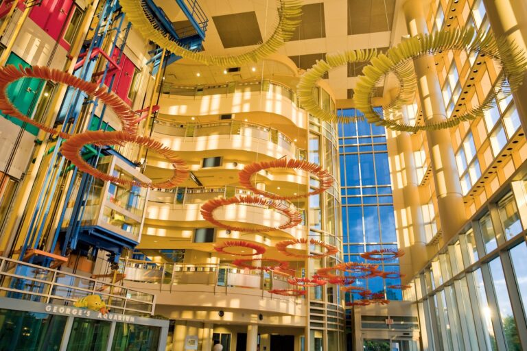 inside of building with colorful sculpture hanging from the ceiling