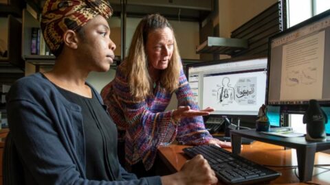 physician explaining medical information on a computer to a patient