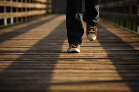 closeup of person walking on wood plans on a jetty