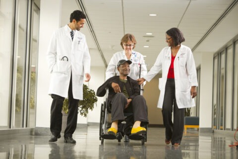 patient in wheelchair with doctors