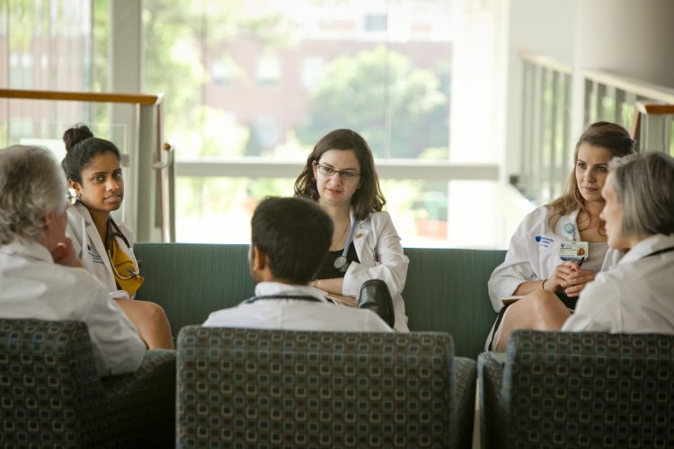 medical students talking while seated in a circle